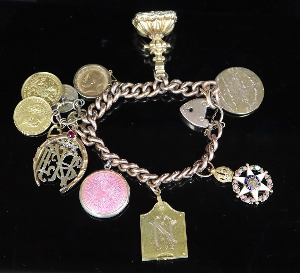 A late 19th/early 20th century 9ct gold curb link charm bracelet,